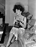 Joan Crawford sitting on the Sofa and Holding a Book in Classic Photo Print (8 x 10)